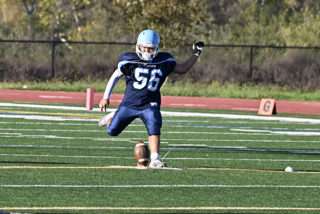#56 Tyler Youn steps into a big kick for the Frosh Trojans