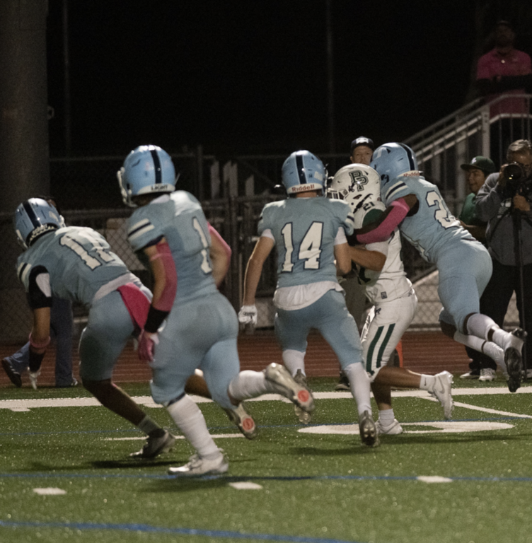 Varsity #20 Deandre Miller and #14 Charlie Carmichael get in on the tackle for the Trojans.   For more great photos of this game and season visit: https://unifootballboosters.smugmug.com/20252026-UNI-TROJANS-FOOTBALL/Varsity