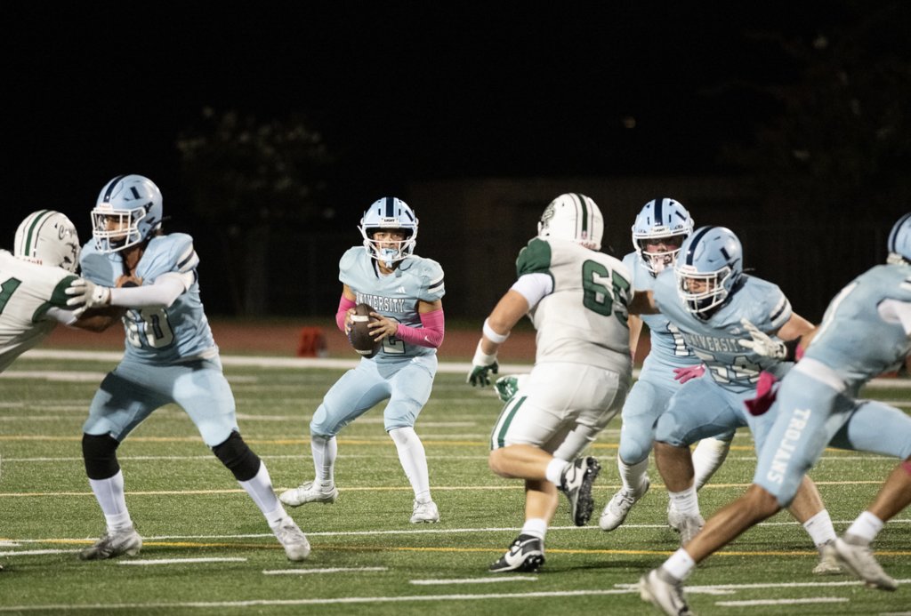 QB Dylan Elmer surveys downfield for a Trojans receiver to pass to.   For more great photos of this game and season visit: https://unifootballboosters.smugmug.com/20252026-UNI-TROJANS-FOOTBALL/Varsity