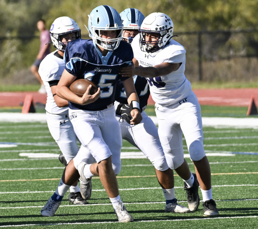#15 QB Vitor Campos scrambles away from pressure of the Bulldogs.  For more photos visit: https://unifootballboosters.smugmug.com/20252026-UNI-TROJANS-FOOTBALL/2025FROSH
