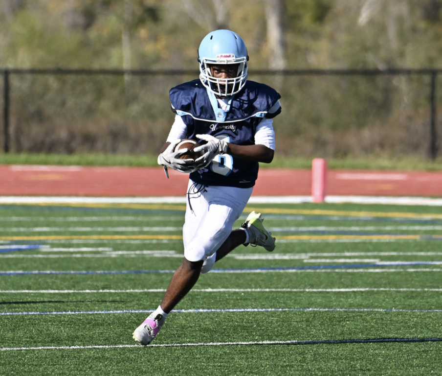 #8 running back Noah Thomas turns the corner with a powerful run for the Trojans.  For more photos visit: https://unifootballboosters.smugmug.com/20252026-UNI-TROJANS-FOOTBALL/2025FROSH