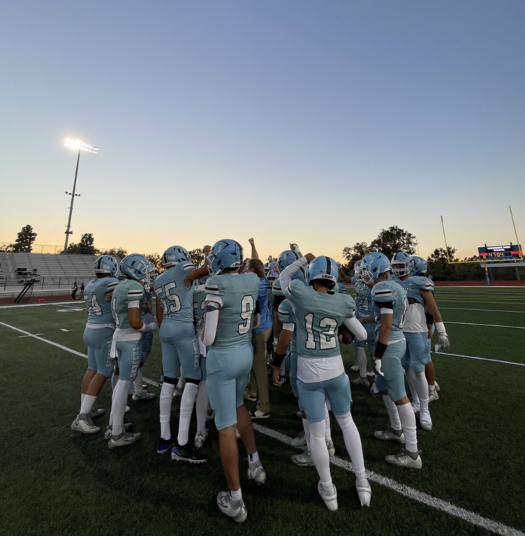Trojans Varsity in Team Huddle during pre-game.  For more great photos of this game and season visit: https://unifootballboosters.smugmug.com/20252026-UNI-TROJANS-FOOTBALL/Varsity