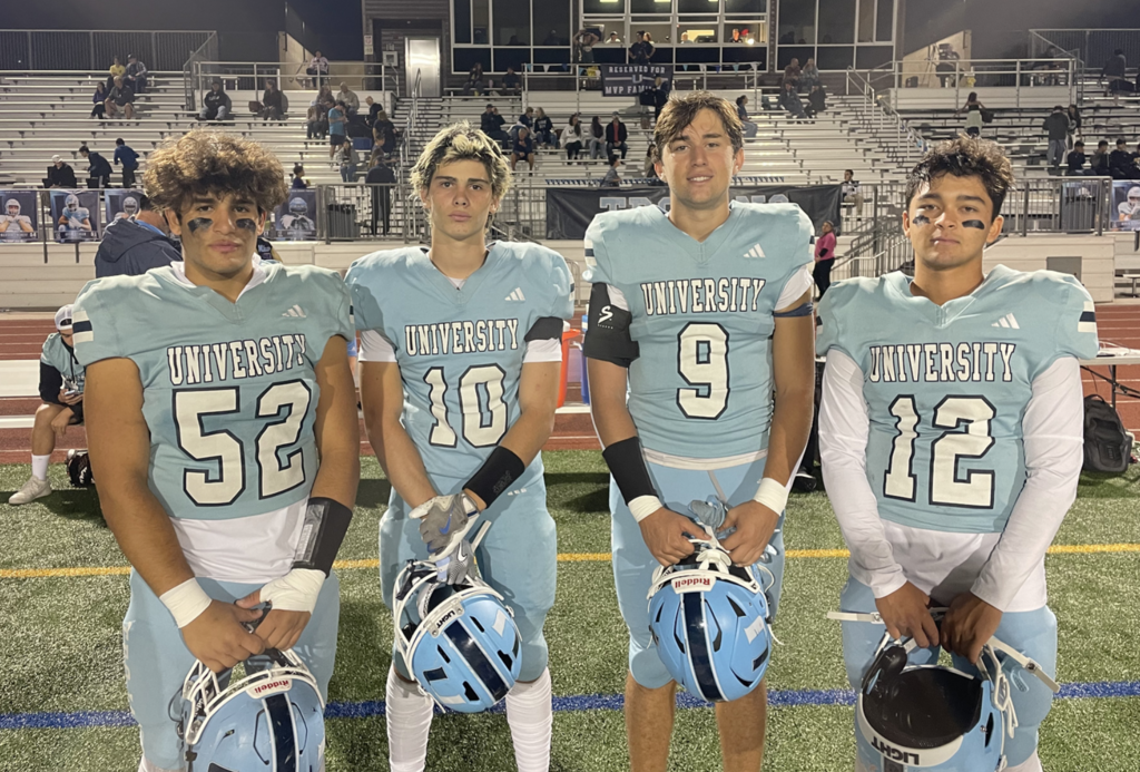 Game Captains take to the center of the field for the coin toss.  For more great photos of this game and season visit: https://unifootballboosters.smugmug.com/20252026-UNI-TROJANS-FOOTBALL/Varsity