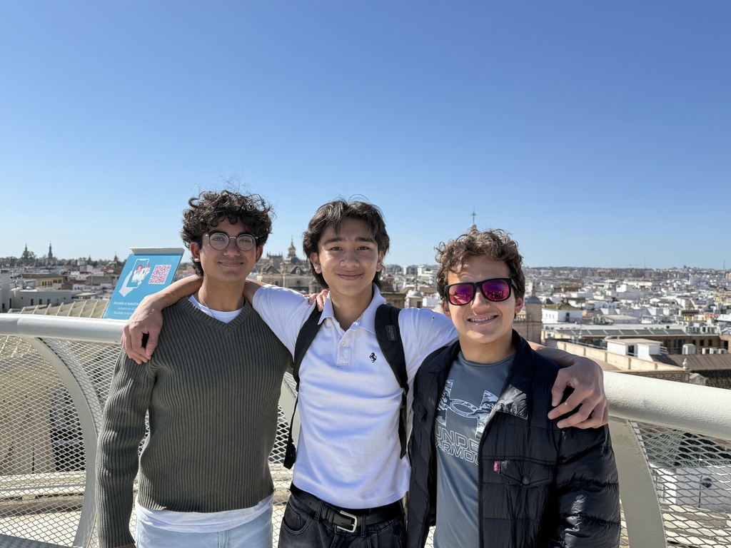 MUN Students Remy, Rahul, and Noah standing on top of a mushroom/like structure in Seville, Spain