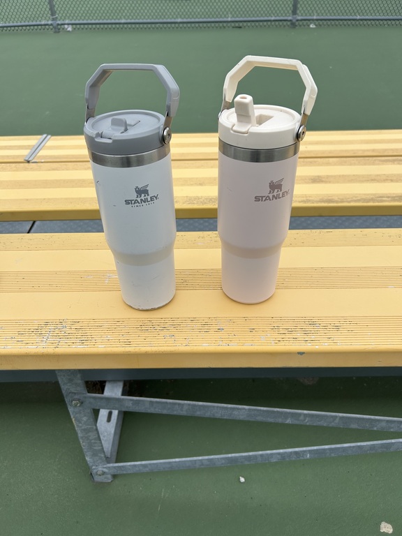 These water bottles were left after practice. They have been put in the shed.