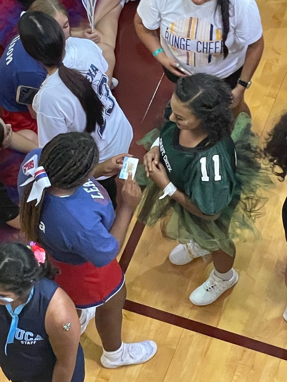 Bella pinning it forward to another cheerleader at camp who she thought was a good leader!