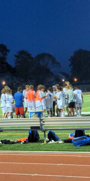 Players coming together after a hard earned victory over Lansing Eastern, 8-3.
